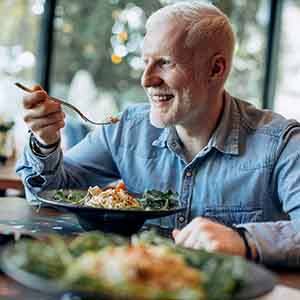 A middle-aged man eating healthy foods for his meal