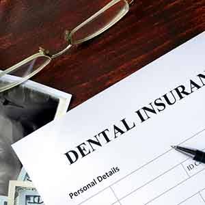 A dental insurance form on a wooden desk