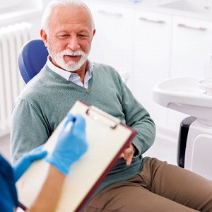 older man talking with the dentist