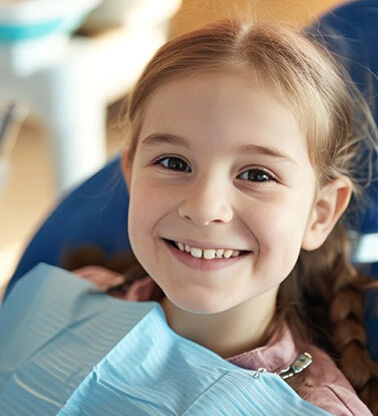 a child smiling before getting dental treatment