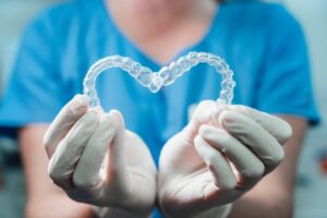 Dentist using clear aligners to make a heart